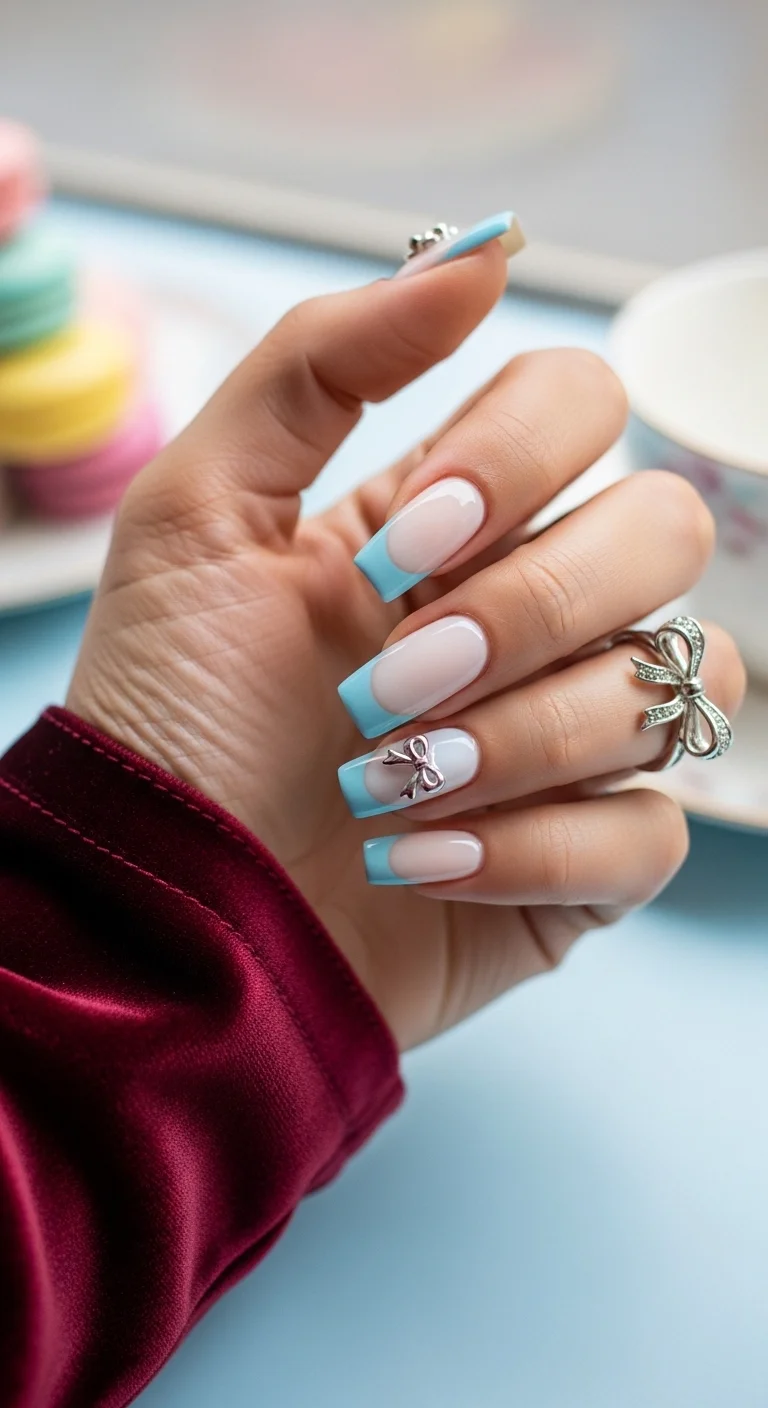 Baby blue French tips with 3D silver bow charms.