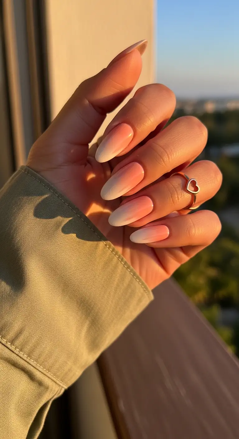 Medium oval nails featuring a smooth, vertical ombre gradient blending from soft peach at the cuticle to creamy white at the tip